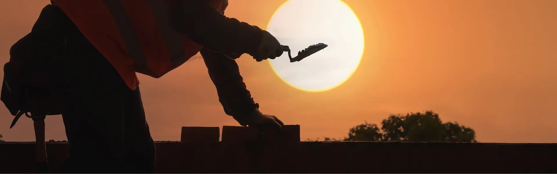 Bricklayer over sunset